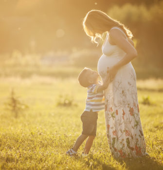 Child Kissing Mother's Pregnant Belly